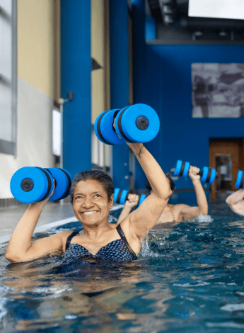 Older woman doing exercises in the pool 